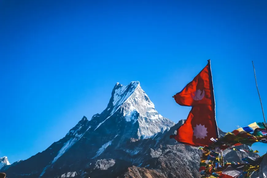 Mardi Himal Weather - Flag of Nepal, fluttering near the snow-covered Mardi and Fishtail region